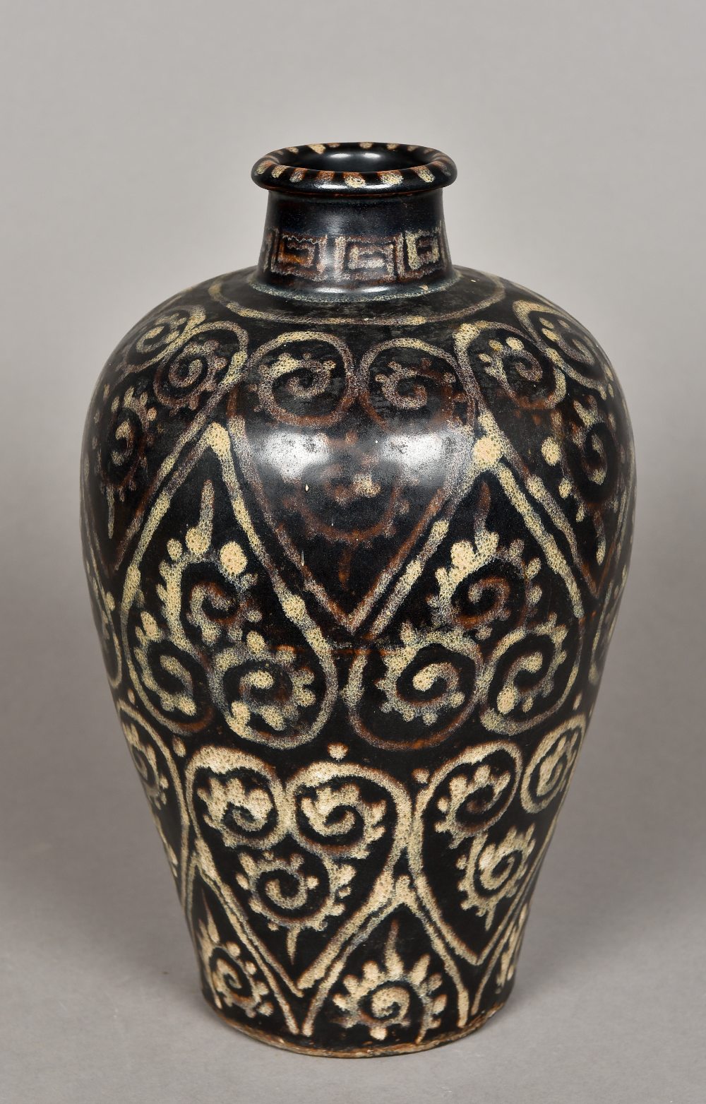 A Chinese Jizhou Guri style vase Decorated with ruyi scrolls on a dark black/brown ground,