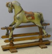 An early 20th century child's rocking horse Of small proportions with dapple grey decoration. 81.