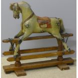 An early 20th century child's rocking horse Of small proportions with dapple grey decoration. 81.