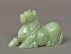 A Chinese carved jade horse Modelled recumbent. 9.5 cm long.