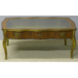 A late 19th century gilt metal mounted walnut vitrine The glazed hinged serpentine top above the