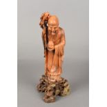 A Chinese carved soapstone figure of Shou Lao Typically modelled with staff and peach,