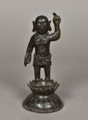 A Chinese Ming patinated bronze model of Buddha Modelled standing with one hand raised and wearing