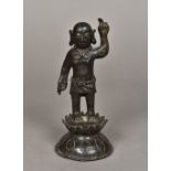 A Chinese Ming patinated bronze model of Buddha Modelled standing with one hand raised and wearing