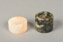 Two Chinese carved hardstone archer's rings Of typical form. The largest 3.5 cm diameter.