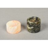 Two Chinese carved hardstone archer's rings Of typical form. The largest 3.5 cm diameter.