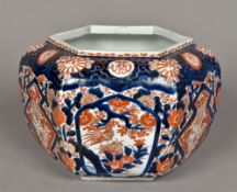 A Japanese porcelain jardiniere Of hexagonal section, decorated in the Imari palette. 21 cm high.