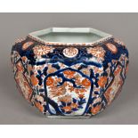 A Japanese porcelain jardiniere Of hexagonal section, decorated in the Imari palette. 21 cm high.