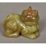 A Chinese carved green and russet jade temple lion Typically worked. 7 cm wide.