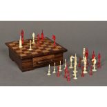 A 19th century Indian carved ivory and stained ivory chess set Housed in an inlaid wooden