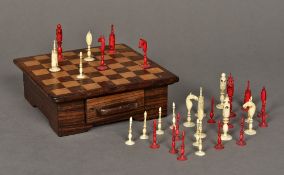 A 19th century Indian carved ivory and stained ivory chess set Housed in an inlaid wooden