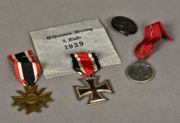 A group of three German World War II medals Including: an 1813-1939 Iron Cross,