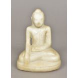 A carved white marble figure of Buddha Typically modelled, seated in the lotus position.