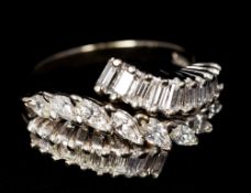 A 14 K white gold diamond ring Set with two rows of baguette cut diamonds flanking a row of