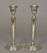 A pair of George V silver candlesticks,