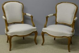A pair of French upholstered open armcha