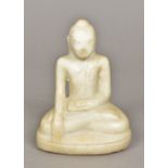 A carved white marble figure of Buddha