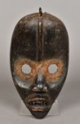 An African carved wooden tribal mask, po