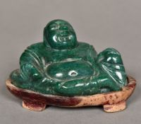 A Chinese carved green stone Buddha