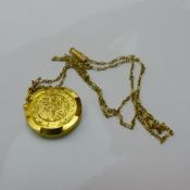 An Edwardian photo locket on a 15 ct gold chain