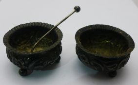 A pair of silver salts and a spoon