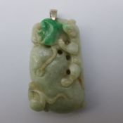 A Chinese carved green and celadon jade pendant Worked as a salamander and bat on a fruit with