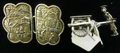 A 19th century Chinese Canton silver buckle and a small Chinese silver figure of a street trader