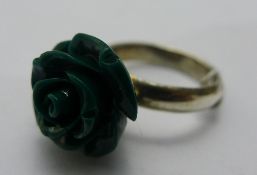 A silver and green flower ring