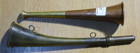 A copper and brass hunting horn and a brass warning horn