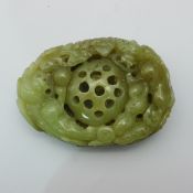 A carved jade pebble