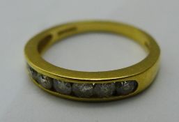 An 18 ct gold half eternity ring set with half a carat of diamonds