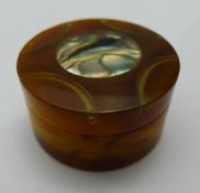 A small abalone shell inset pill box