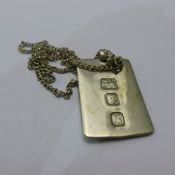 A silver ingot on a silver chain