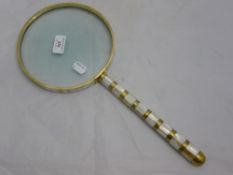 A large mother-of-pearl magnifying glass