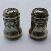 A pair of small silver pepper pots