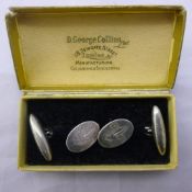 A pair of silver Scout cufflinks