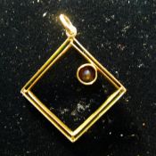 A 1930s rose gold pendant set with a garnet