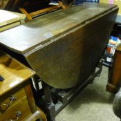 An early 20th century oak gate leg table