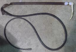 An antler handled leather hunting whip