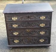 A Georgian carved oak chest of drawers