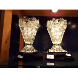 A pair of pressed glass vases on pedestal bases