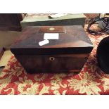 An early 19thC rosewood sarcophagus shaped tea caddy raised on bun feet