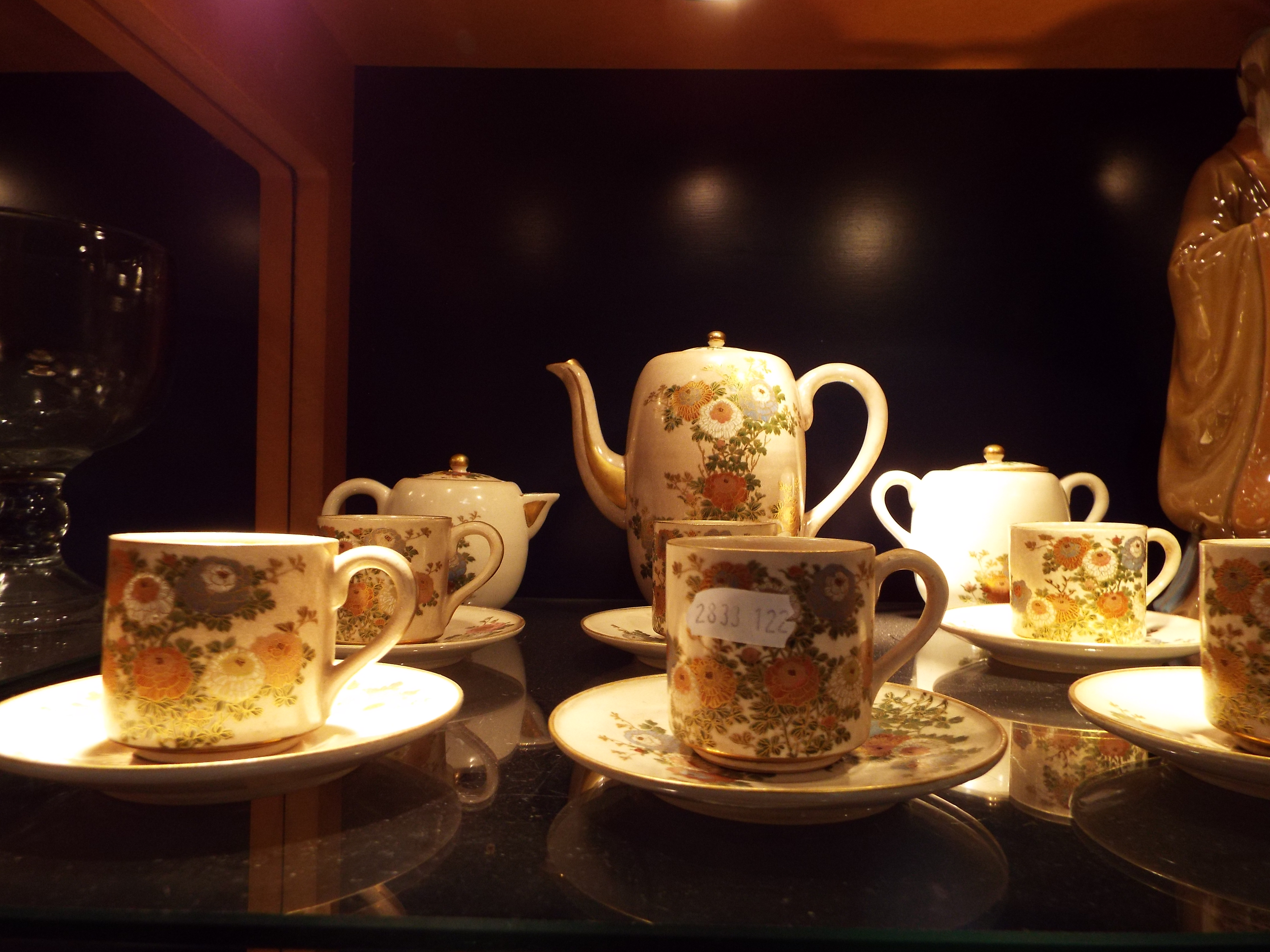 A late 19thC early 20thC Satsuma coffee set decorated with enamel flowers and gilt highlights