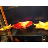 Two foiled glass gold star-shaped dishes and a large red and gold foiled glass dish