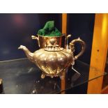 A Victorian silver plated pumpkin shaped teapot with berry and leaf finial and raised on foliate