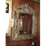 A modern gilt painted floral carved wall mirror