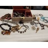 A box of assorted costume jewellery to include beads, bangles,