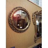 A circular bevelled glass gilt framed mirror