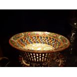 An early 20thC canton pierced bowl decorated with floral and figural panels