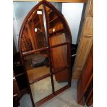 A 20thC gothic arch shaped six panel wall mirror